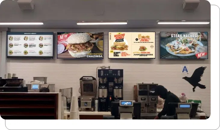 A digital menu board for a coffee shop running menu and ads simultaneously