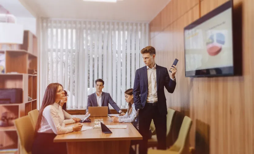 Digital signage screen placed in office meeting room showing Clock feed using Pickcel digital signage software