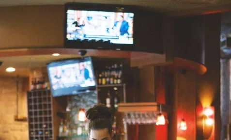 Digital signage placed in a bar displaying news update feed from Pickcel's digital signage ESPN news app