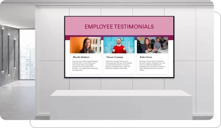 A digital signage screen showing client reviews in an office