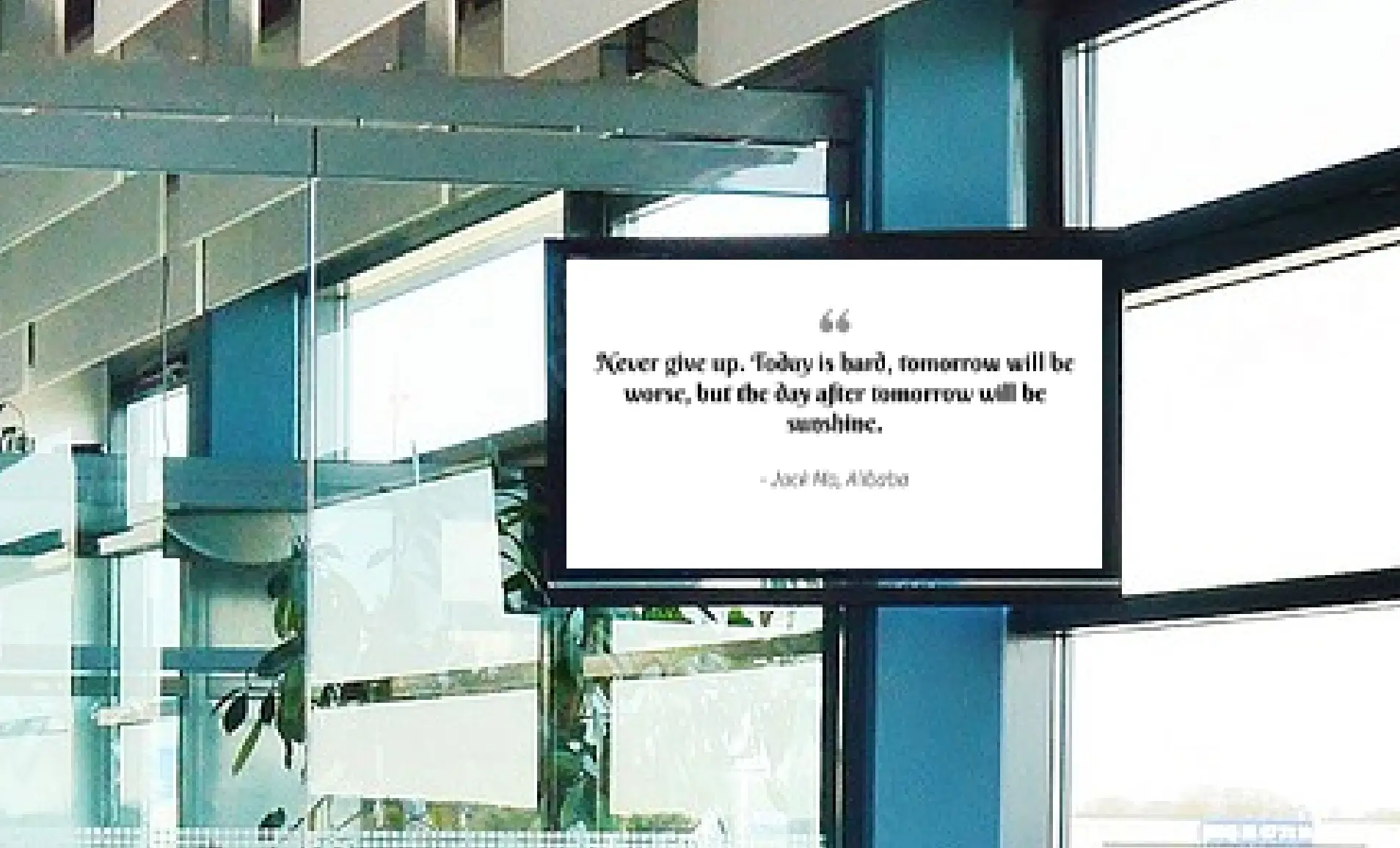 Digital signage screen placed outside meeting room showing motivational quote using Pickcel digital signage software