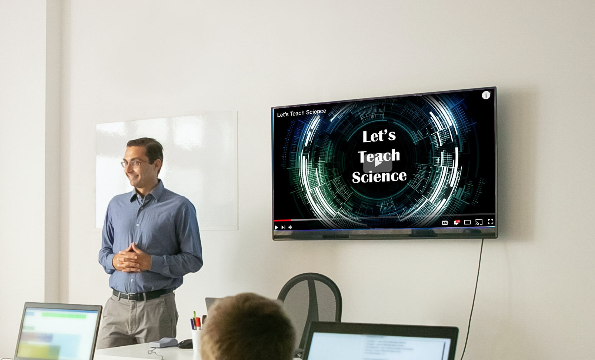 a classroom equipped with digital signage displaying educational video from Youtube video app