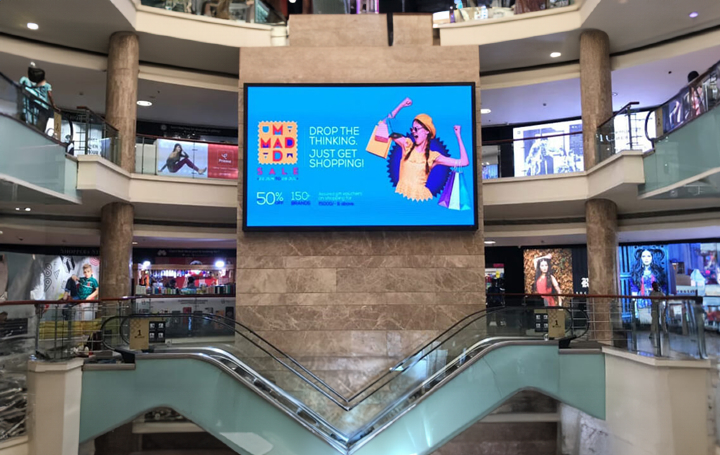 Asian paints customer choosing paint color in interactive digital signage display placed in-store powered by Pickcel's custom digital signage software