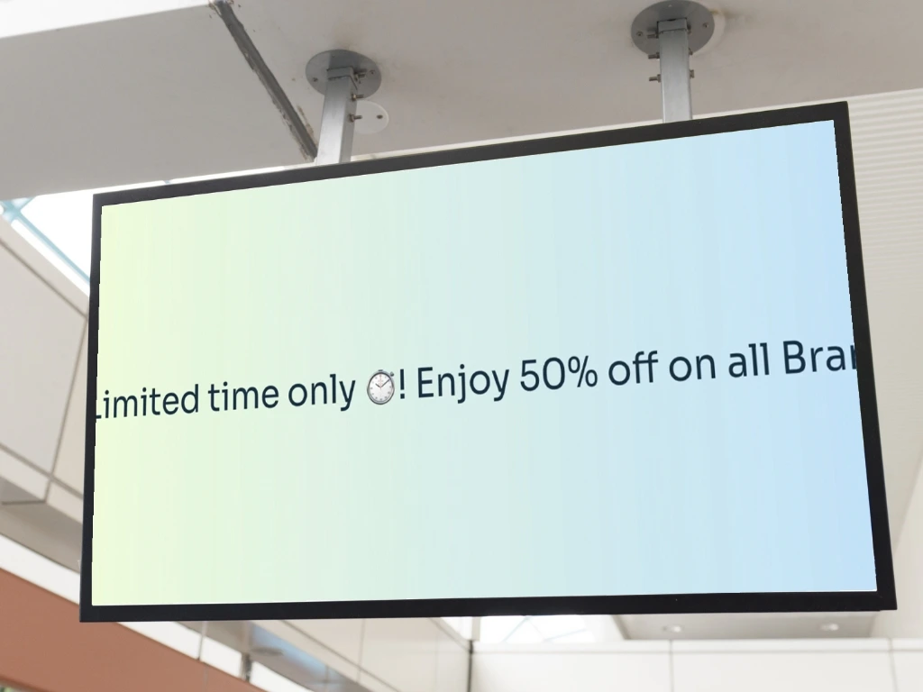 Offer announcement about 50% off on all brands is displayed with scrolling text on digital signage