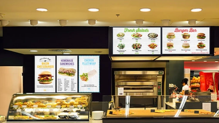 A cafe with digital menu boards showing the menu