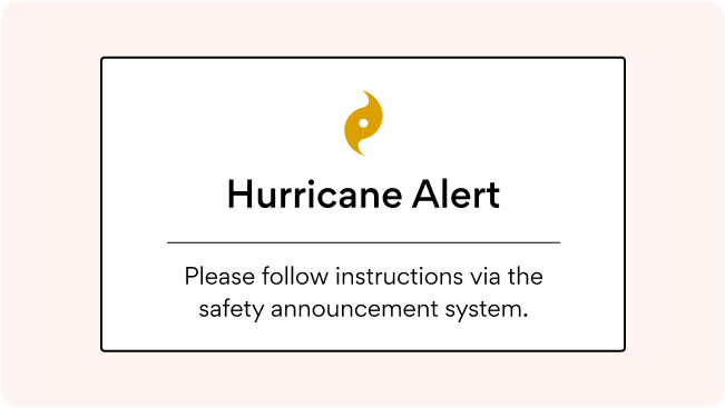 An office digital signage screen flashing an emergency message