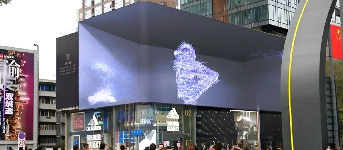 An exterior 3D digital billboard shows blue & pink bubbles blowing out in the air