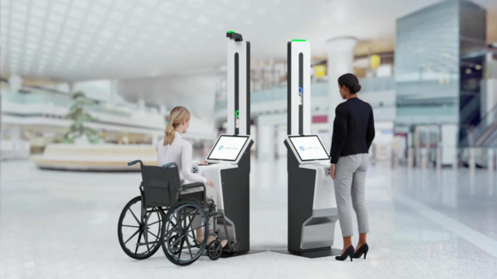 A woman in a wheelchair and a woman without any disability using accessibly designed kiosks.