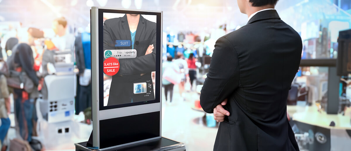 Man checking an AR-enabled screen in a cloth store.