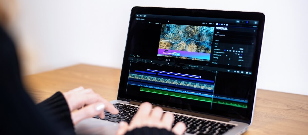 A women using video editing software for YouTube on her laptop