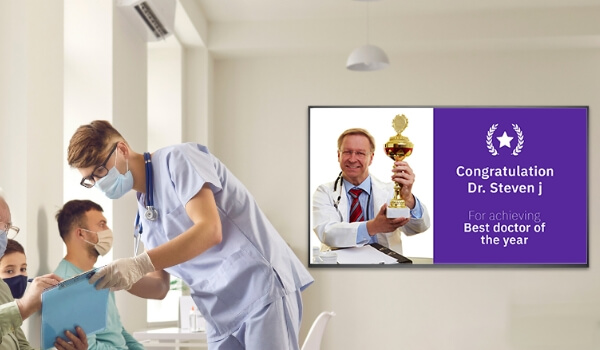 healthcare unit digital signage displaying information about their doctor winning an award. Thus creating brand awareness as a marketing strategy.