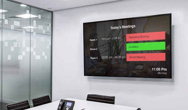 A wall mounted digital signage display showing the conference room availability status