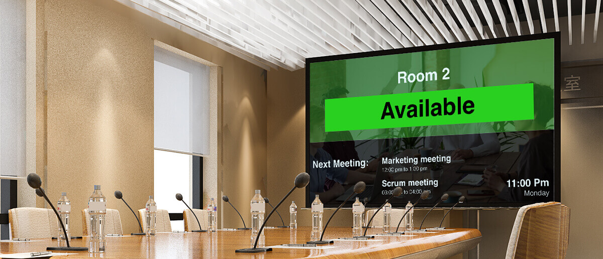 conference room equipped with digital signage screen displaying meeting room availability