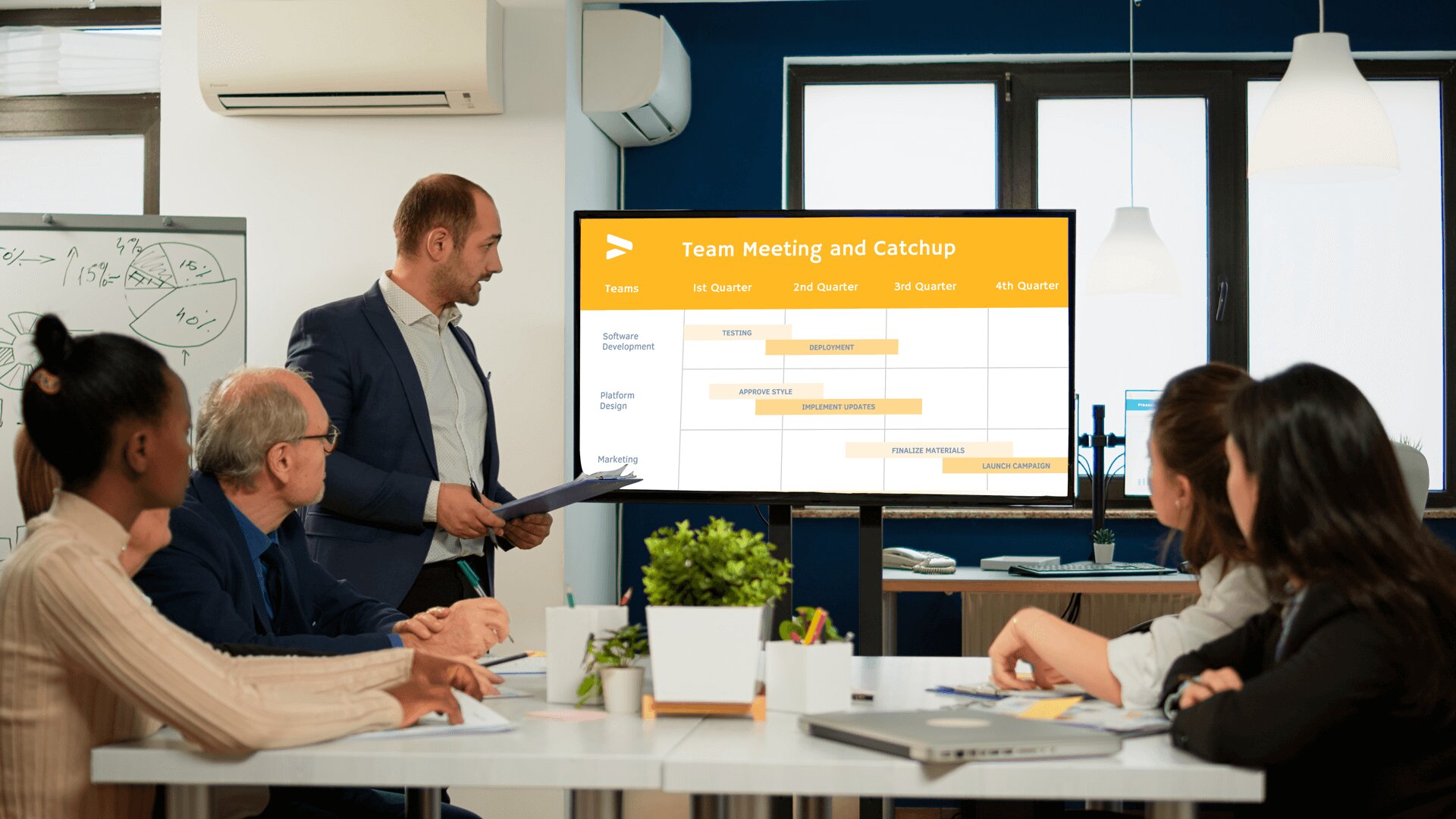 A team of employees discusses their schedule inside an office. They refer to a digital screen showing their work timelines