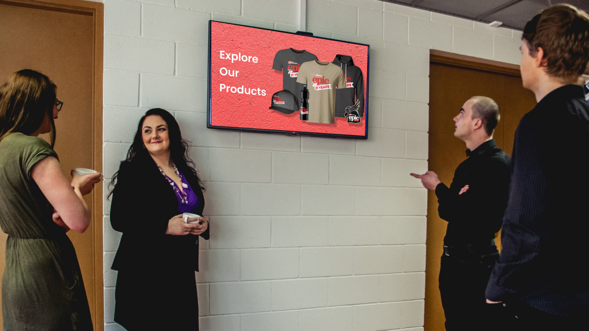 Digital screen showing the company merch at a corporate office.