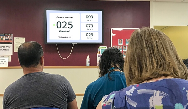 healthcare waiting room digital signage displaying token numbers to manage the patient queue seamlessly as a part of marketing strategy