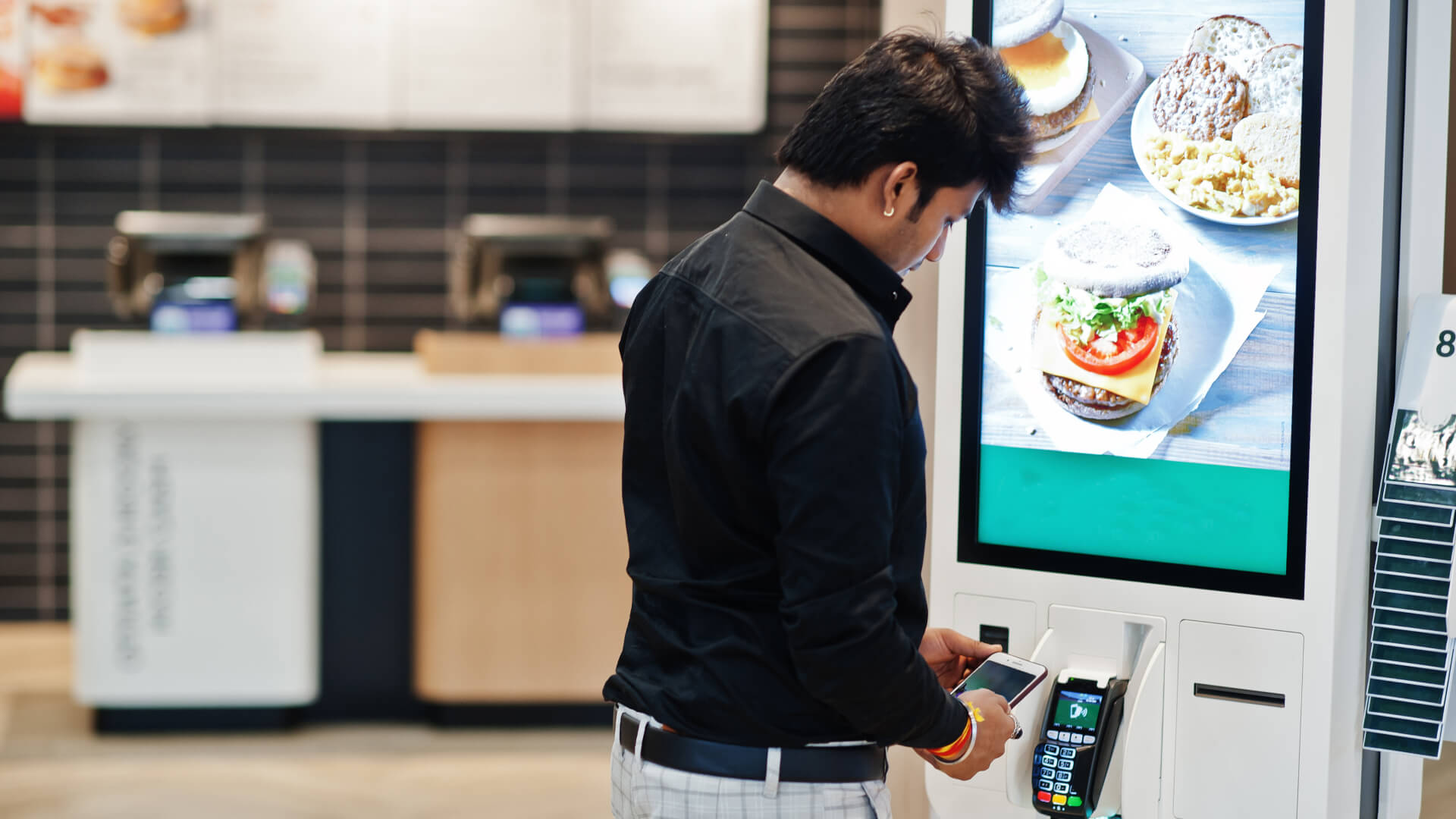 A QSR using self-service kiosks for helping customers order fast.