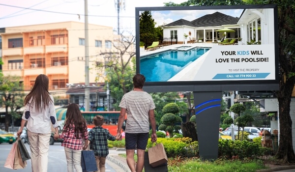 Digital Signage displaying programatic content for a family passing by it