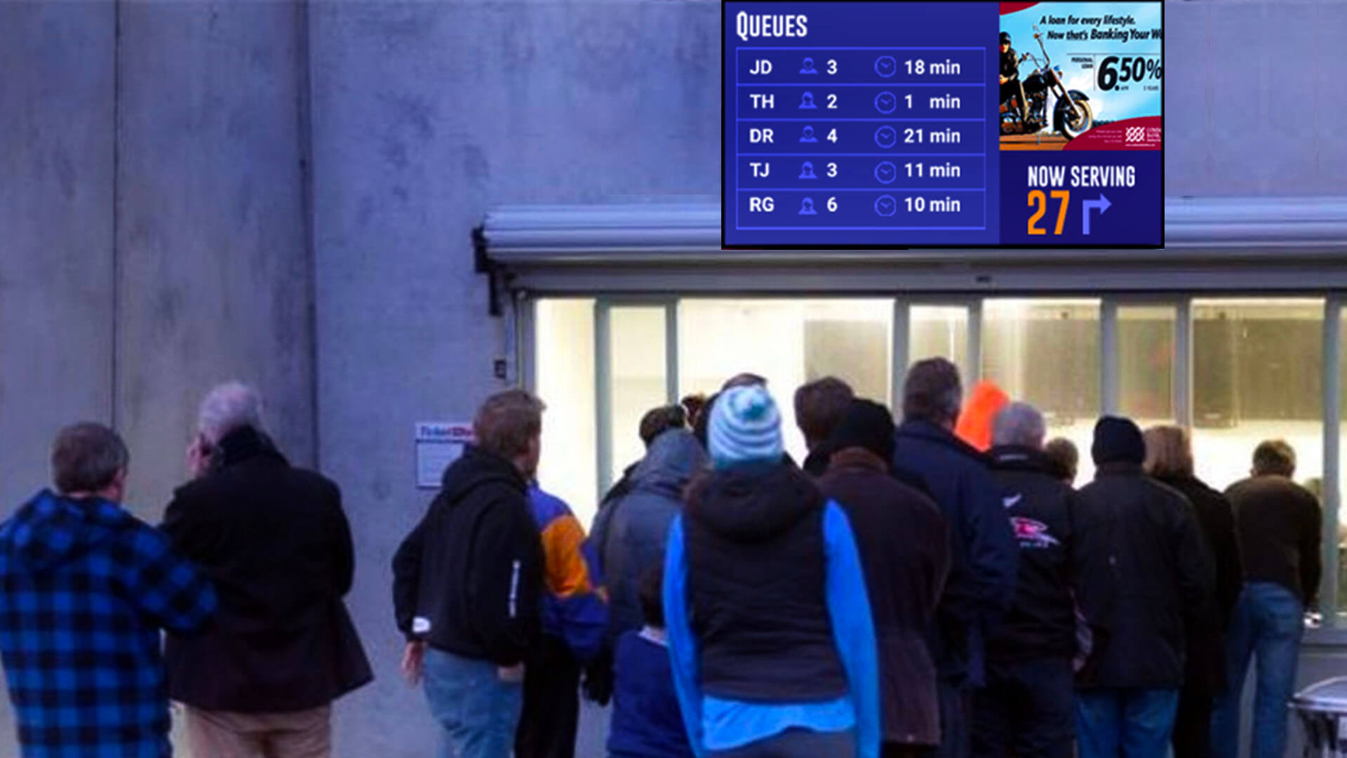 a digital screen showing token numbers outside a stadium