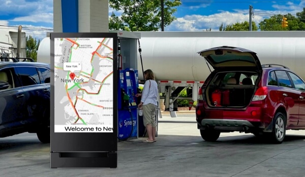 A digital signage at a gas station shows the live traffic map of New York city