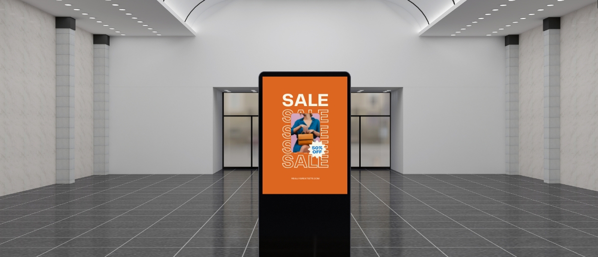 A digital signage standee shows a retail marketing content