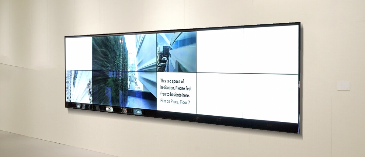 A museum wall equipped with digital signage screens