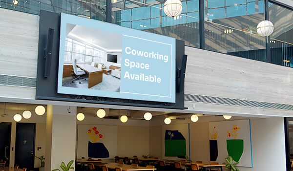 coworking space entrance digital signage screen displaying message - coworking space available