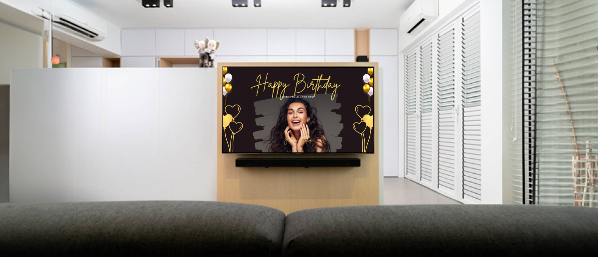 A TV showing birthday message by DIY digital signage in a small office lobby.