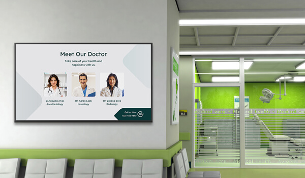 Healthcare digital signage installed inside a patient waiting room shows the list of available doctors with their names and profiles