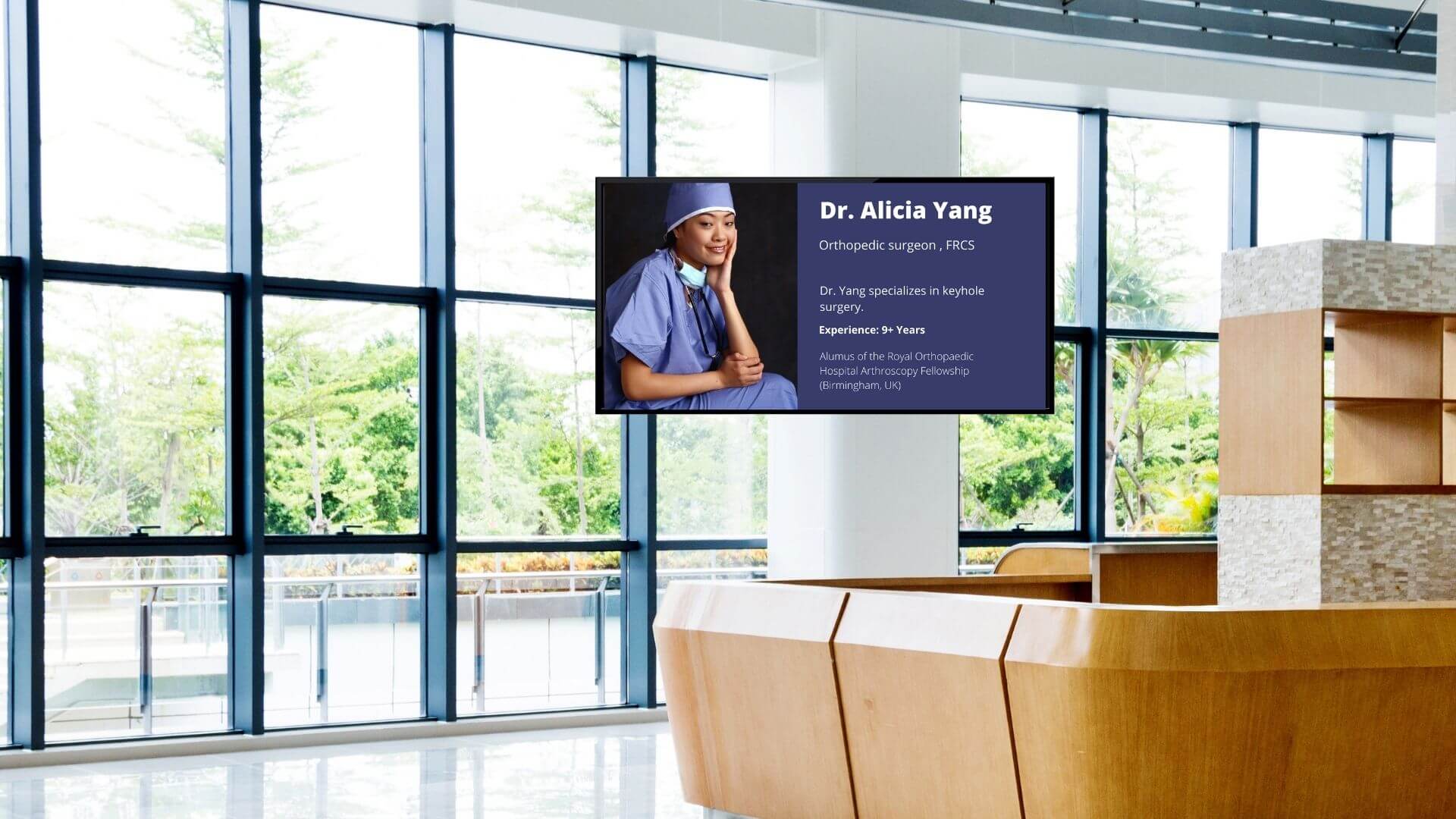 A hospital reception shows a doctor’s profile on digital signage