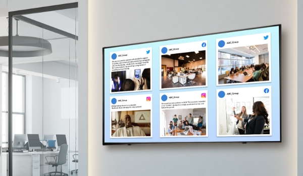 A social wall in an office lobby shows the company's posts on Twitter, Facebook & Instagram