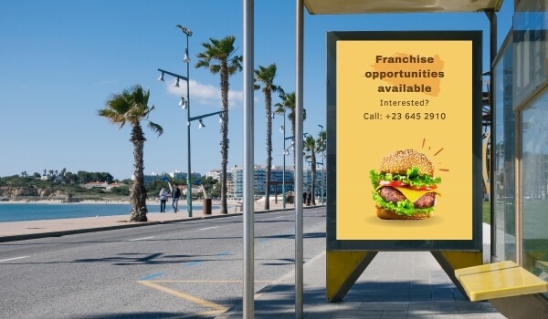 A bus stop digital signage shows an advertising that says Franchise opportunities are available.