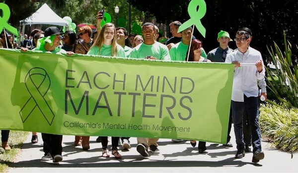 people walking on streets with banners and creating mental health awareness initiated by a california health facility as a part of marketing strategy