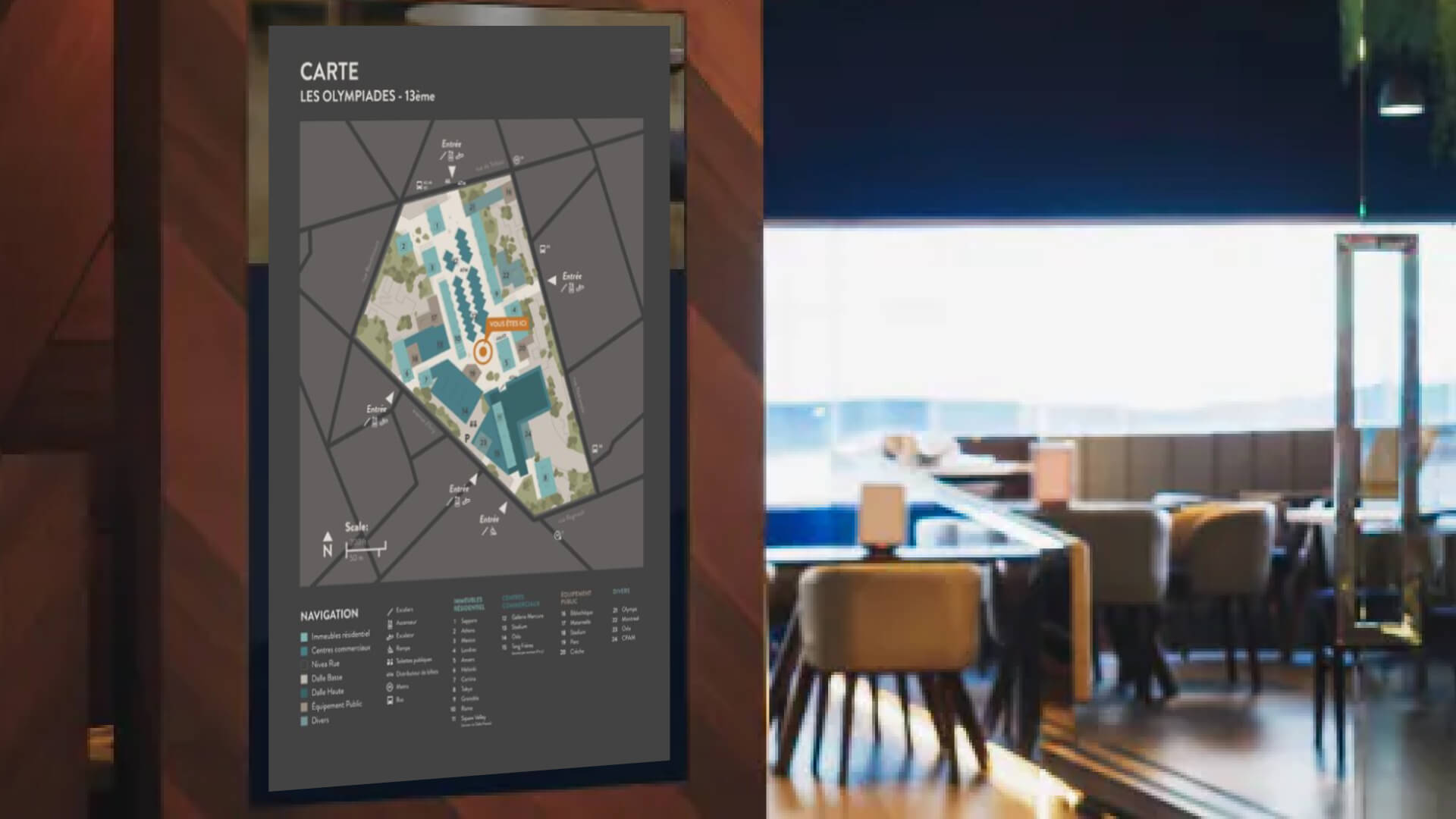 A hotel dining area with a digital signage wayfinding map of the hotel.