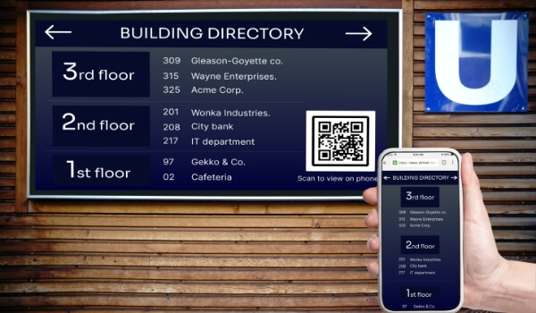 a person holding mobile to scan qr code displaying on an interactive digital building directory screen