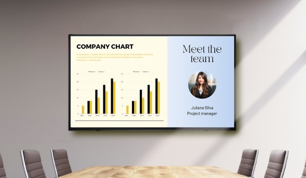 A conference room display shows company dashboards & employee profiles using a digital signage CMS