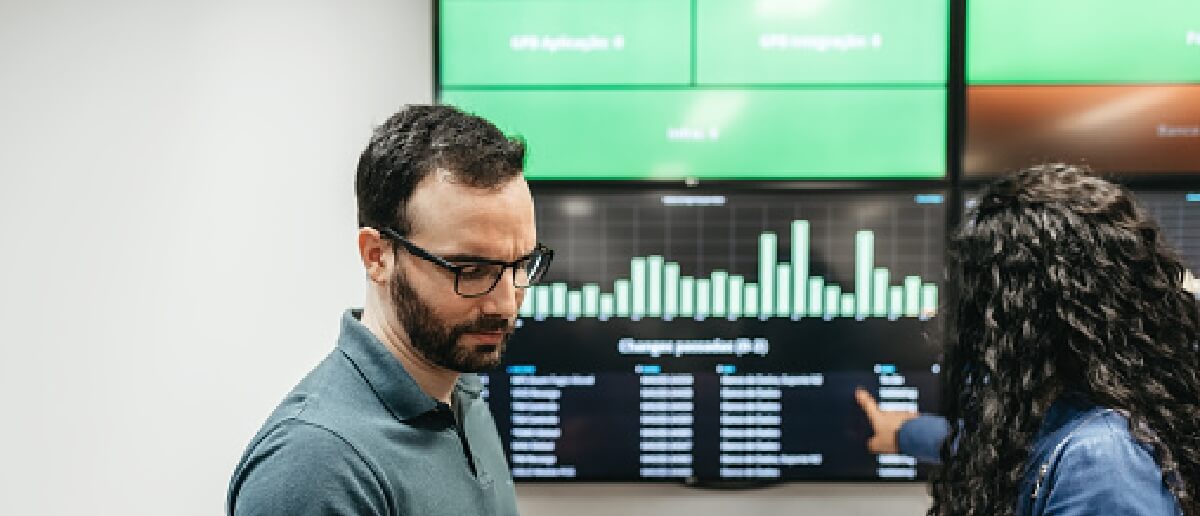 office emplyoee viewing digital signage displaying dashboard with important KPIs