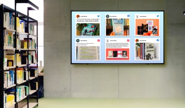 Digital signage screen in a library shows a collage of Twitter, Facebook and Instagram posts