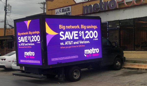A digital billboard truck showing offers from network provider Metro by T-mobile