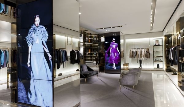 In-store digital displays at Gucci's flagship store show models walking the ramp sporting Gucci products