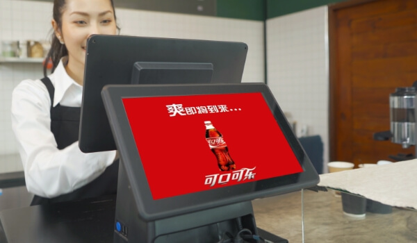 A tablet near the Point of Sale plays a Coca cola ad in Chinese