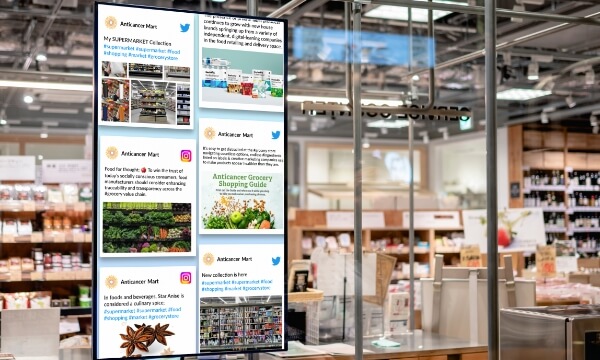 A large digital poster at a big box store's point of sale shows the live Twitter & Instagram feeds