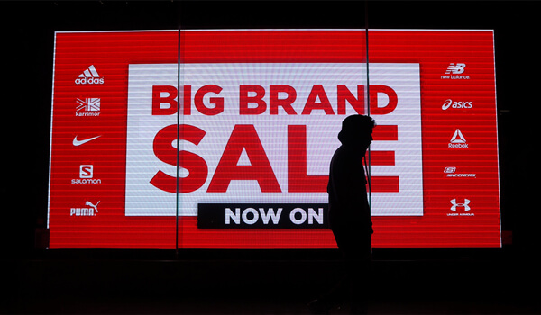 a digital signage screen placed outside a retail store showing promotional content