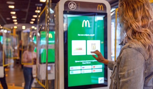 A woman places an order at McDonald's using an interactive self-service kiosk