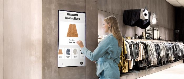 Retail store digital signage screens showing brand advertising and promotional content