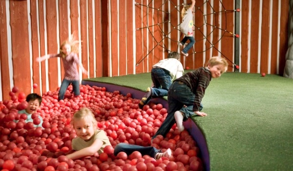Kids playing in a playing area called smaland at an IKEA store