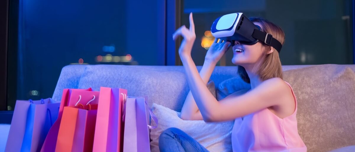 women wearing VR headset and few shopping bags placed besides her.
