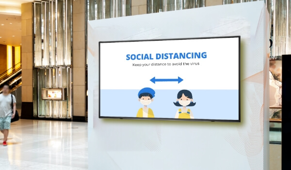 Social distancing message shown on mall digital signage to remind people of their safety