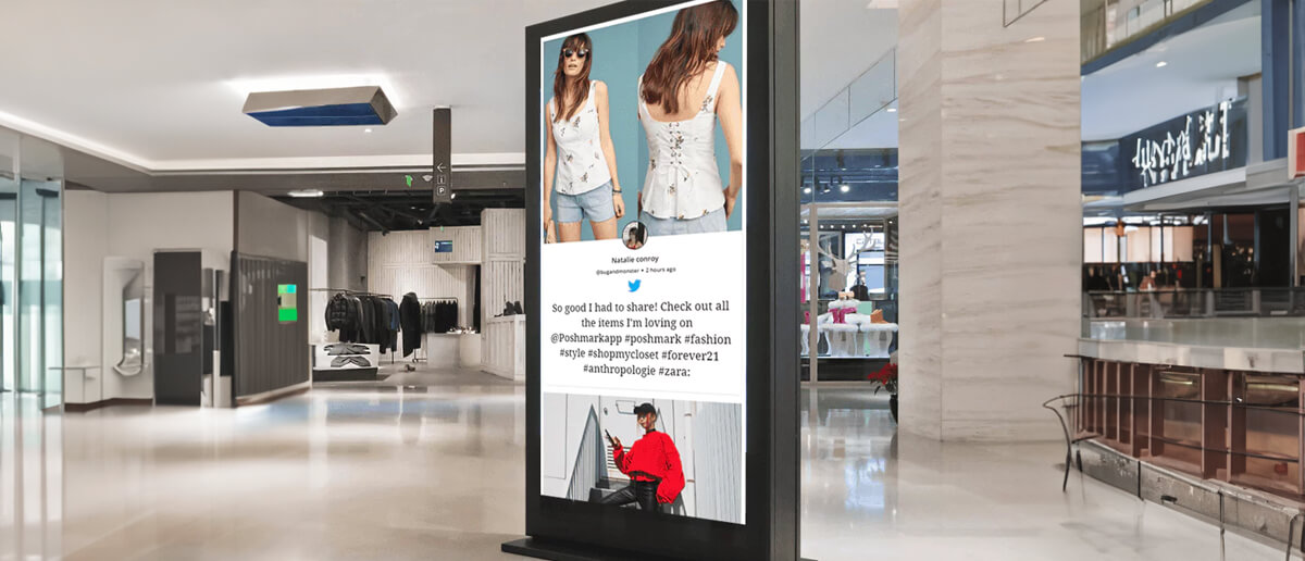 A digital signage screen showing social media posts