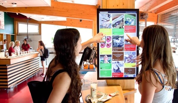 Visitors checking out a social media wall at Zotter's chocolate-tasting session